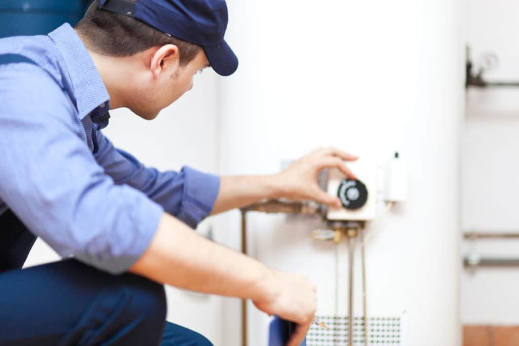 Iceberg plumber working on a residential water heater