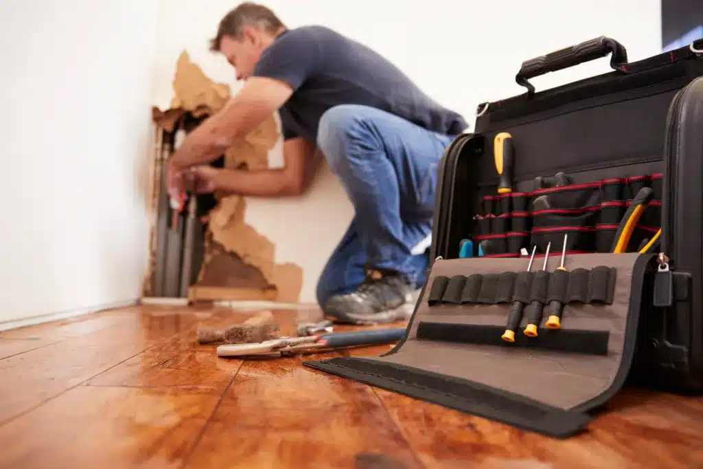 Man repairing burst pipe