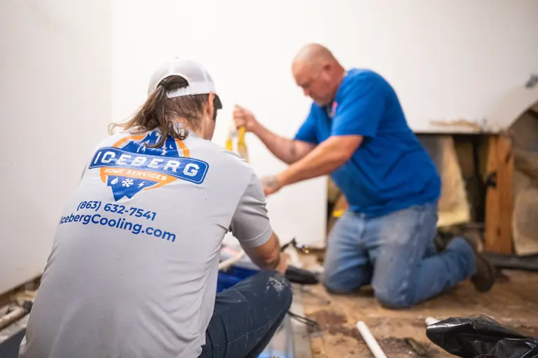 Man repairing burst pipe